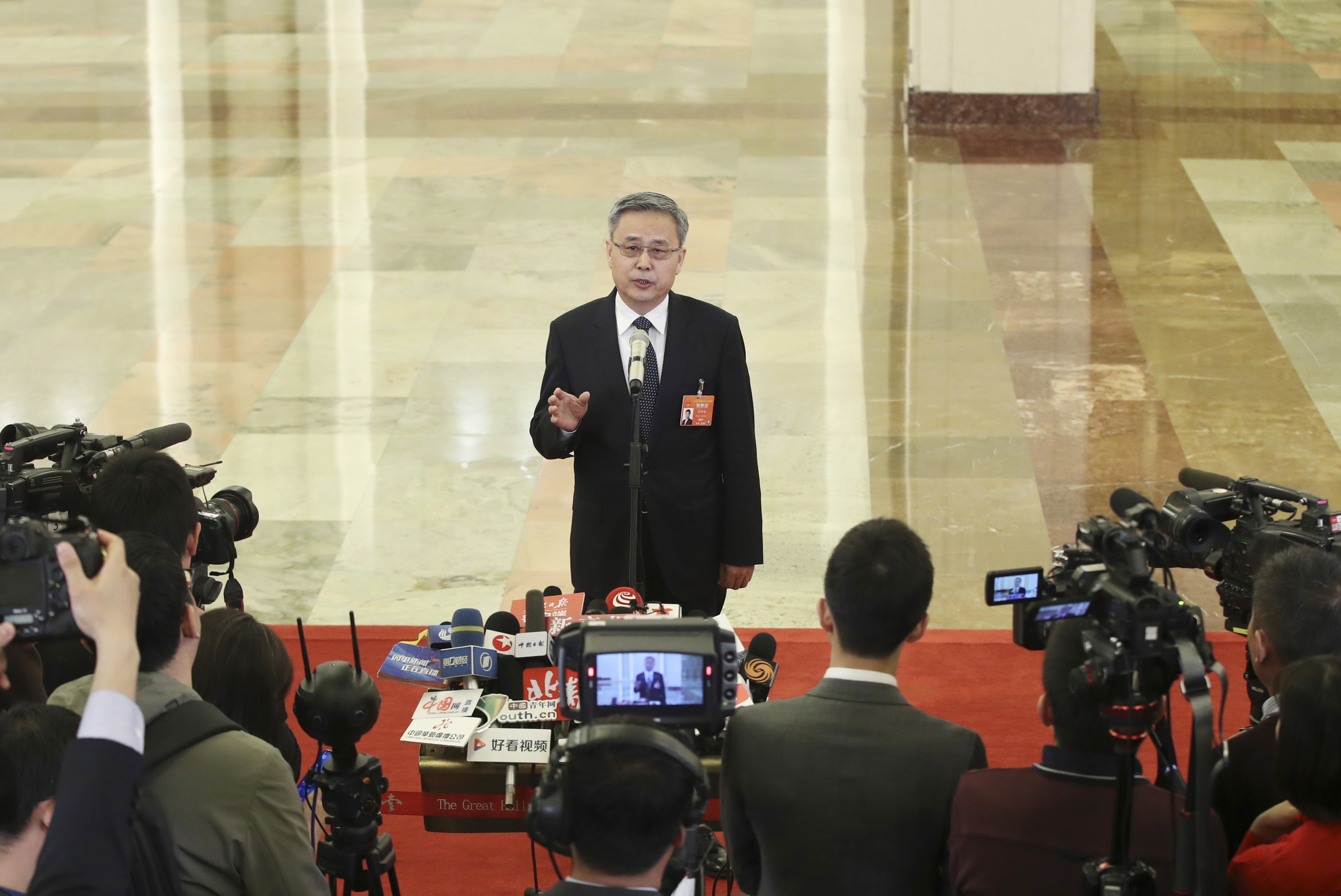 Guo Shuqing addresses the media. Photo: Xinhua