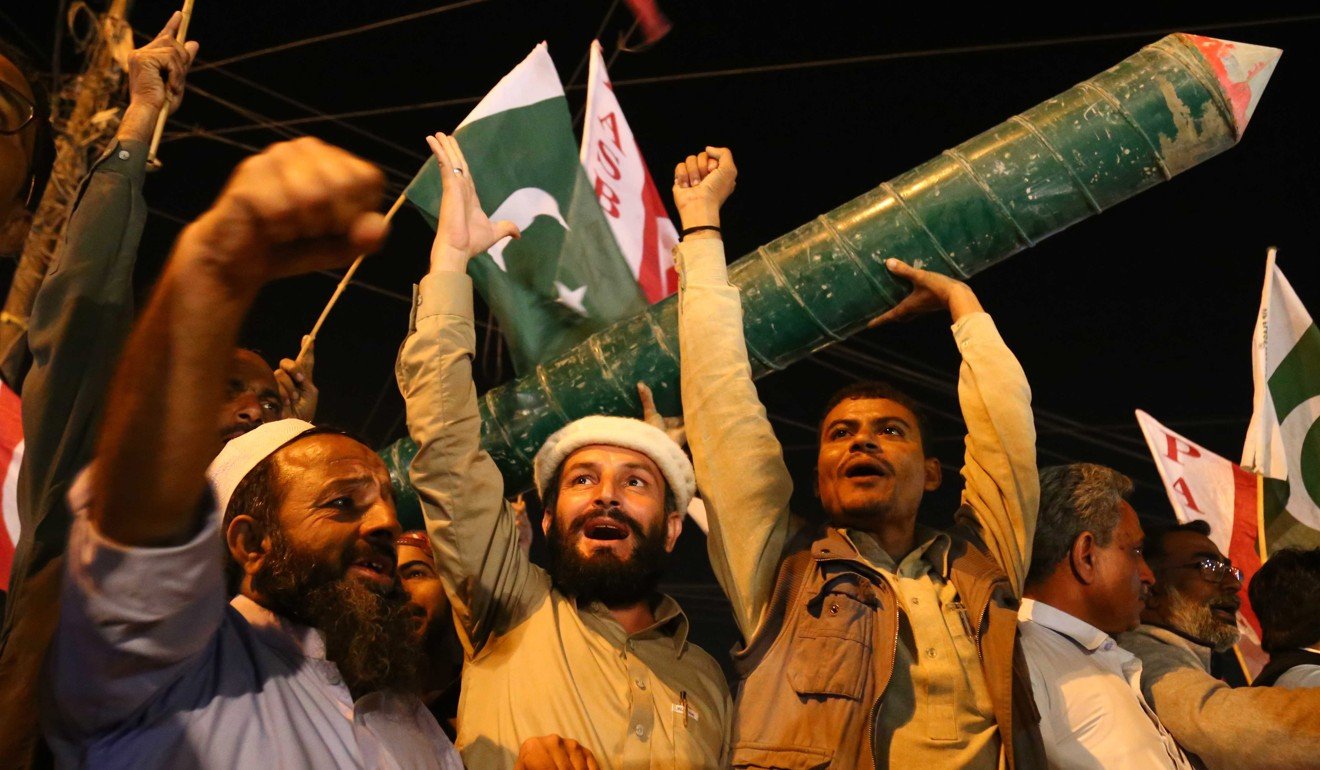 People celebrate after the news of two India fighter jets shooting down by Pakistani Air Force, in Karachi. Photo: EPA-EFE