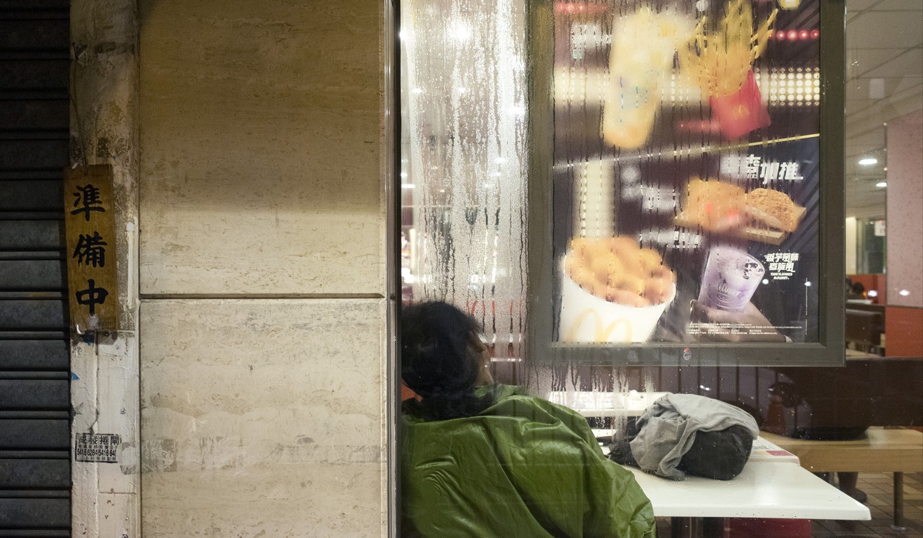A homeless person sleeps in a 24-hour McDonald's restaurant in Sham Shui Po, Hong Kong. Photo: Sam Tsang