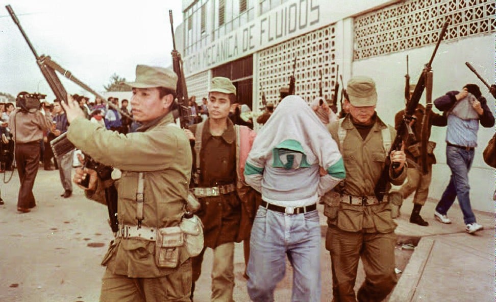 Armed soldiers escort two members of the Shining Path, in Lima, Peru, in 1992.Picture: AFP