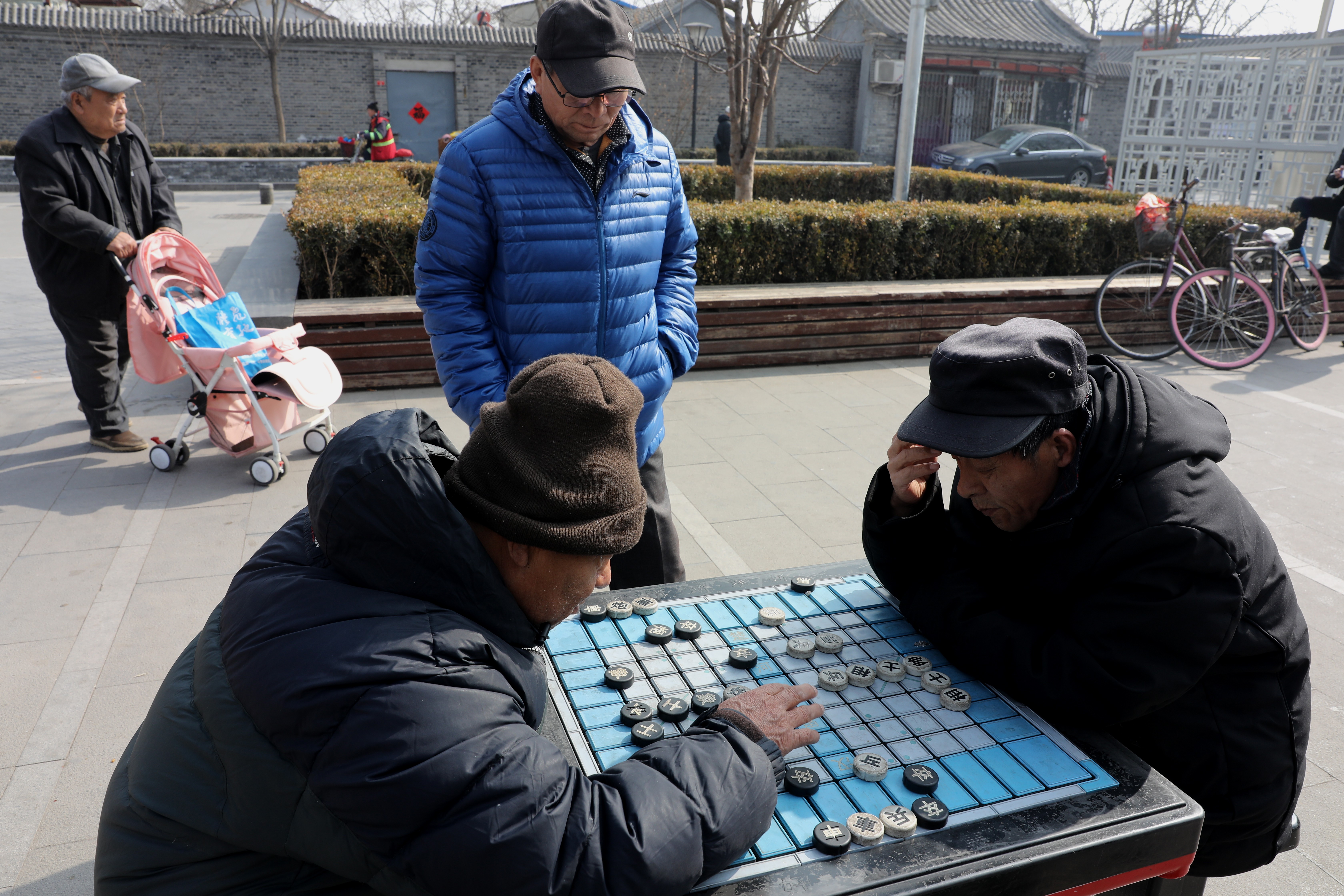 Two men play Chinese chess in a hutong at Bell Tower square in Beijing on February 27, 2019. Photo: Simon Song