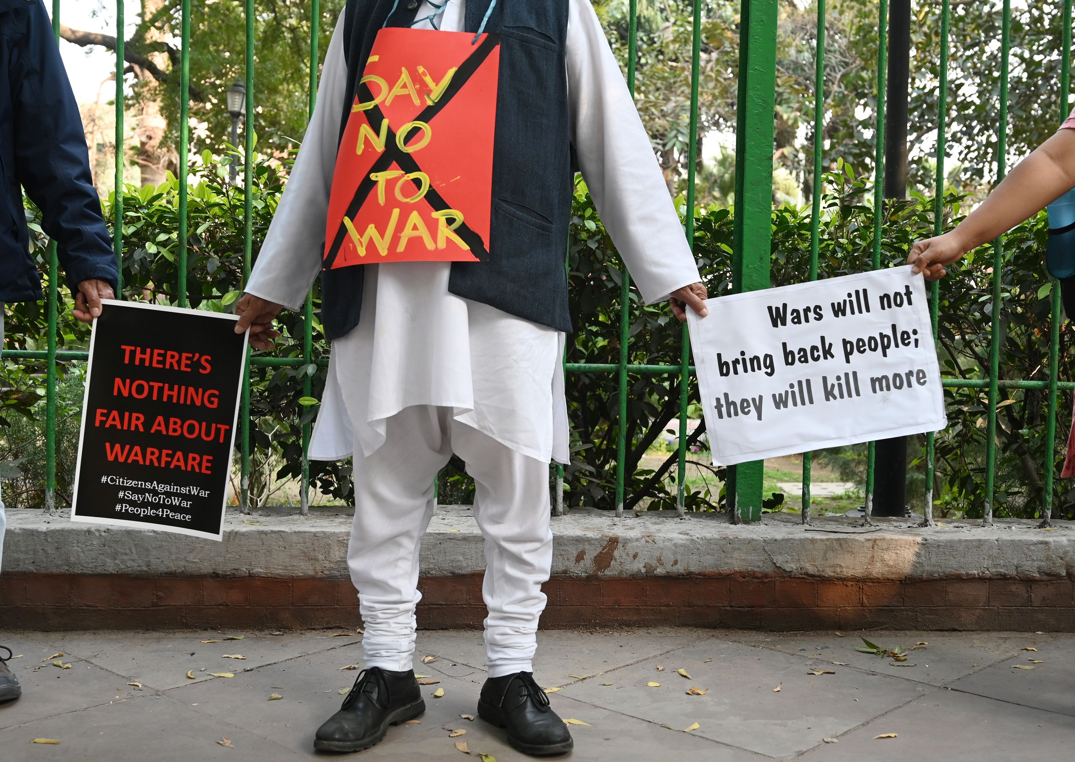 Indian demonstrators hold placards as they form a human chain during an anti-war demonstration called by pacifist organisations in New Delhi on March 4. Photo: AFP