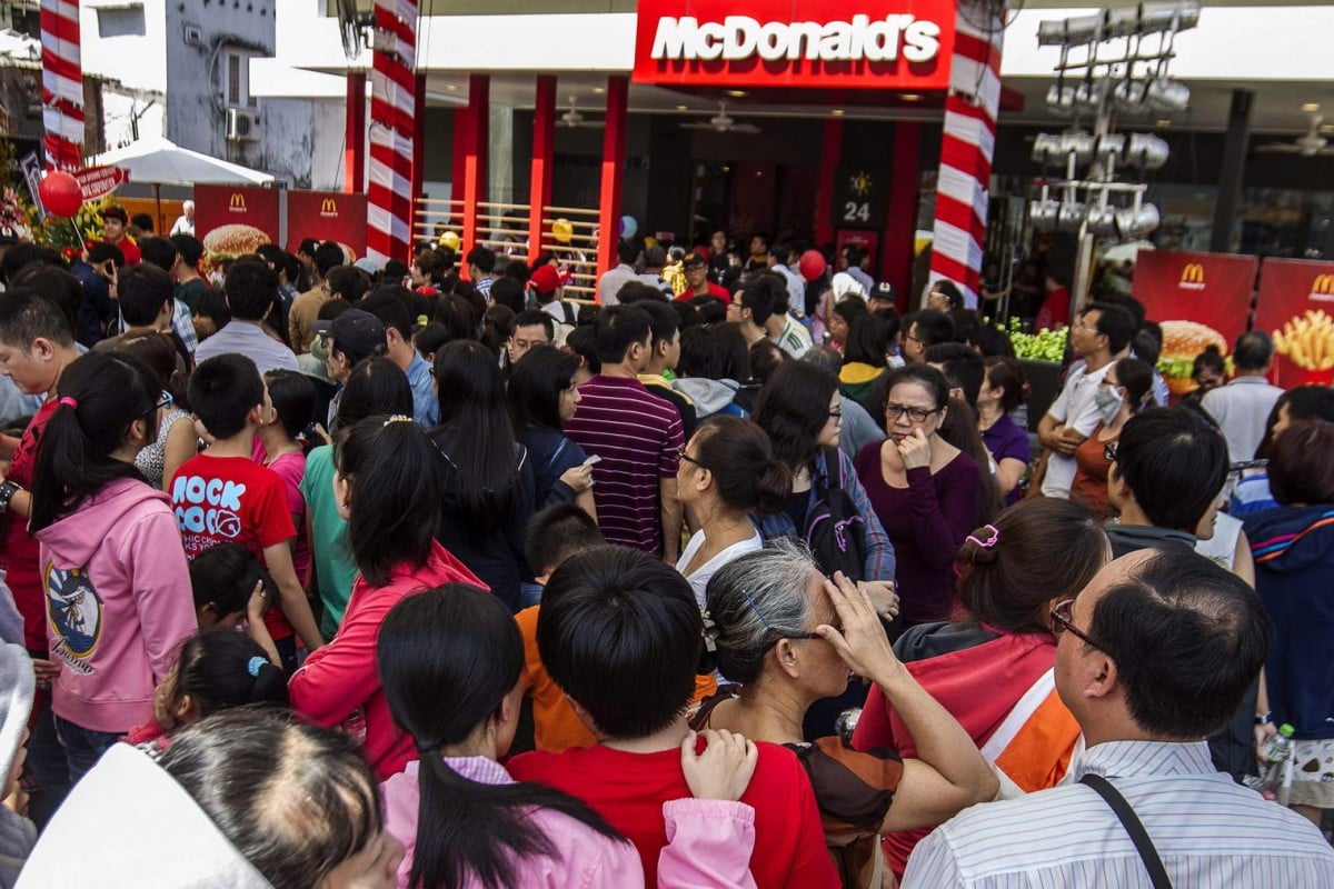 Customers queue outside Vietnam's first McDonald's on its first day of business yesterday. Photo: AFP