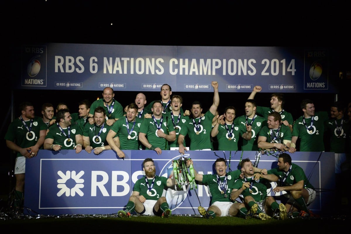 Ireland players celebrate with their medals and the Six Nations Championship trophy after beating France on Saturday. Photo: AFP
