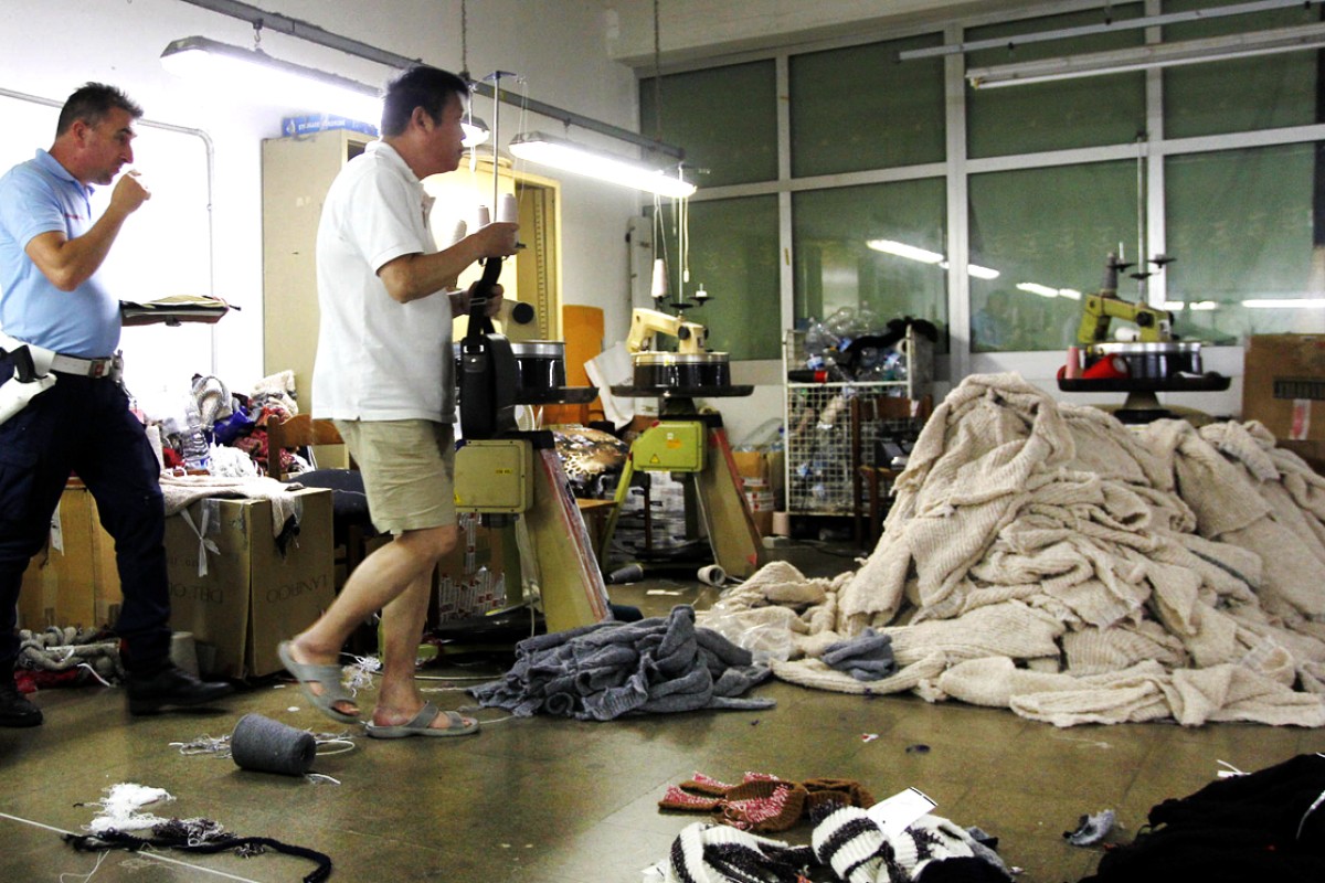 Police inspect a Prato factory. Photo: AP