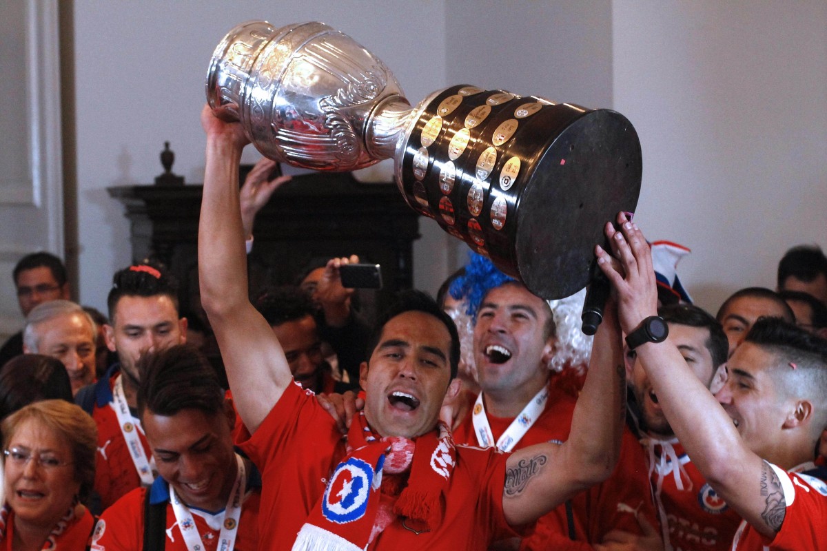 Chile players hold up the trophy at La Moneda presidential palace in Santiago. Photo: AFP