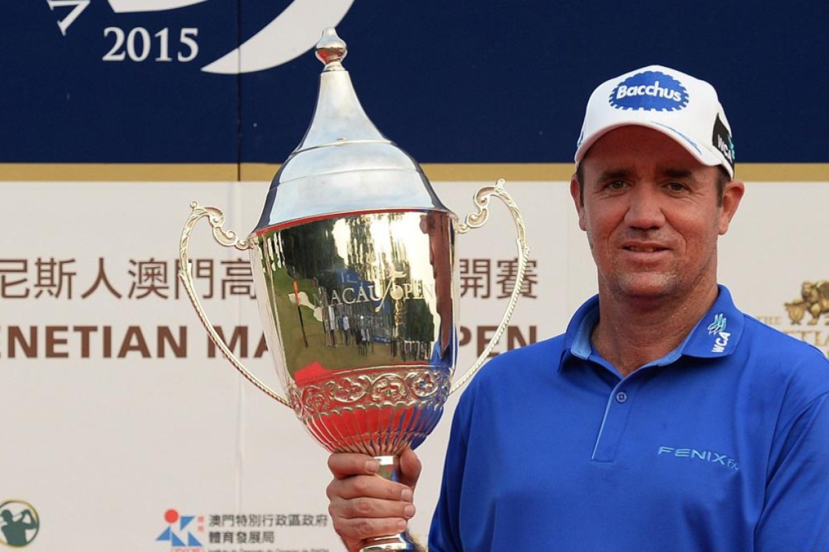 Scott Hend, 42, is all smiles as he clutches the Venetian Macao Open trophy after carding a tournament record 20-under par 264. Photo: AFP    