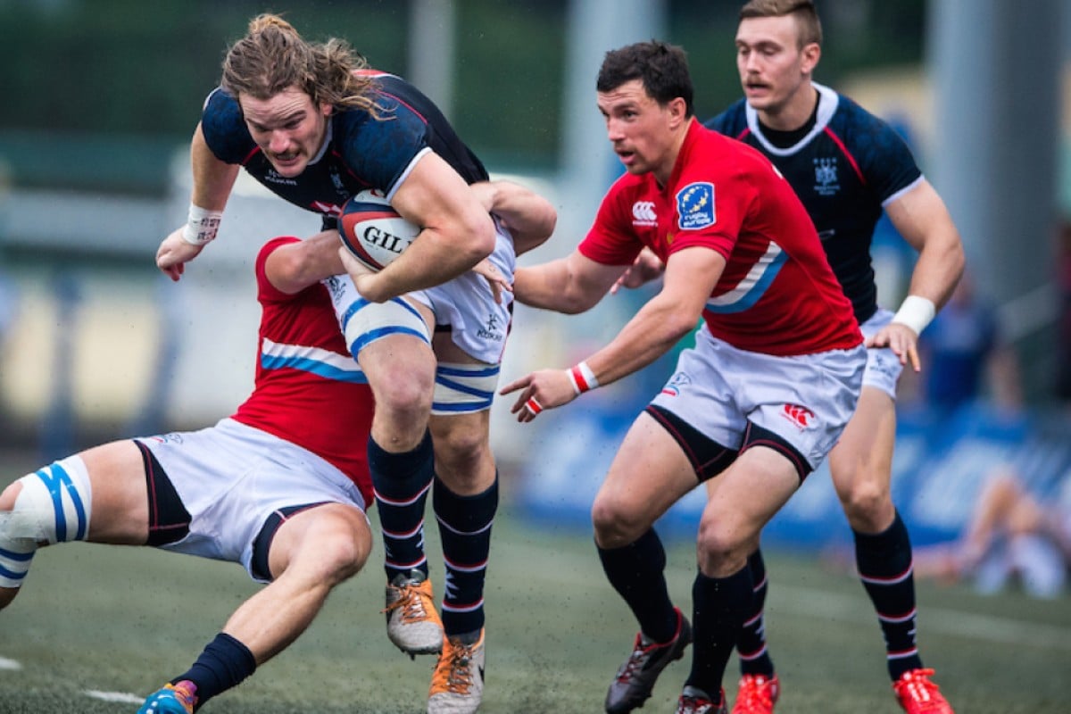 Russia’s defence gets to grips with Hong Kong flanker Jamie Cunningham at HKFC on Saturday. The European side beat Hong Kong 31-12 to claim the inaugural Hong Kong Cup of Nations. Photos: HKRU