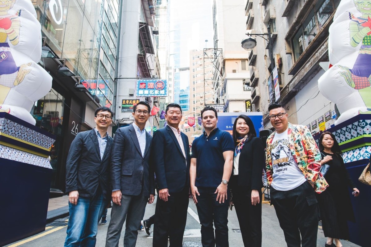 Cobby Leathers, Head of International Business, Sansiri Public Company Limited (in a polo shirt), poses with partners at the entrance of the “Thai Festival by Sansiri at Lan Kwai Fong”