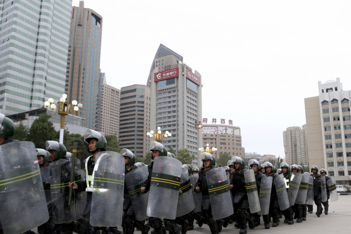 Armed paramilitary policemen run in formation during a gathering to mobilize security operations in Urumqi, Xinjiang Uighur Autonomous Region, in this June 29, 2013 file photo. To match Insight CHINA-XINJIANG/COTTON REUTERS/Stringer/Files ATTENTION EDITORS - THIS PICTURE WAS PROVIDED BY A THIRD PARTY. THIS PICTURE IS DISTRIBUTED EXACTLY AS RECEIVED BY REUTERS, AS A SERVICE TO CLIENTS. CHINA OUT. NO COMMERCIAL OR EDITORIAL SALES IN CHINA.