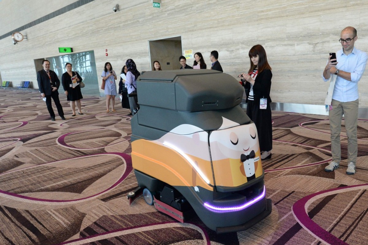 An automatic robot vacuum cleaning the floor at the newly built Changi airport terminal four in Singapore. Photo: AFP