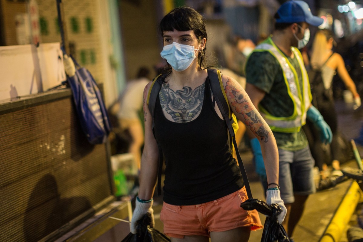 Macau residents volunteer to clean up debris on the streets on August 25, in the wake of Typhoon Hato. Natural disasters that have made the headlines recently magnify the consequences of the political and social choices we’ve made. Photo: EPA