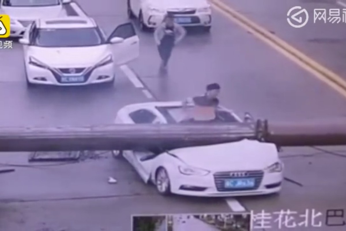 The motorist pictured clambering from the front of his car. Photo: Handout
