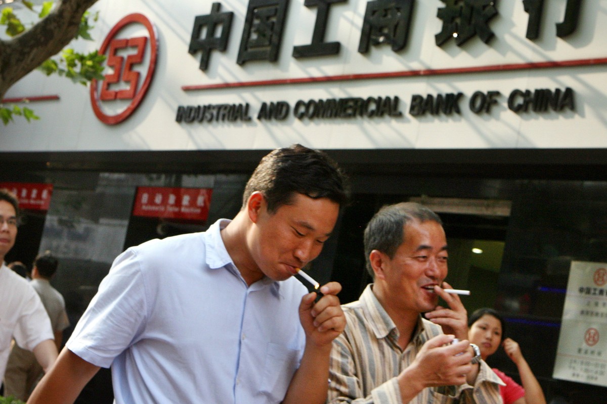 A group of Chinese men walks past a branch of the Industrial and Commercial Bank of China in Shanghai. Photo: AFP