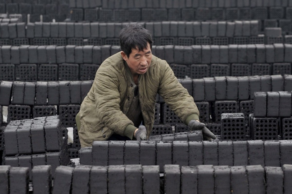 A worker prepares coal briquettes at a plant in Shenyang in northeastern China. Photo: EPA