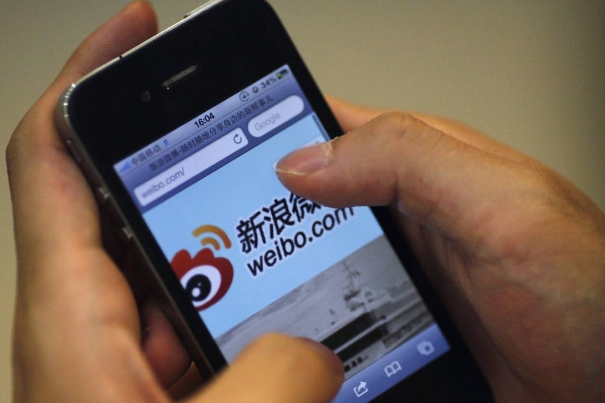 Here S What Happens With Your Data When You Use A Chinese Messaging - a man uses his smartphone to access the sina weibo microblogging site in shanghai china s