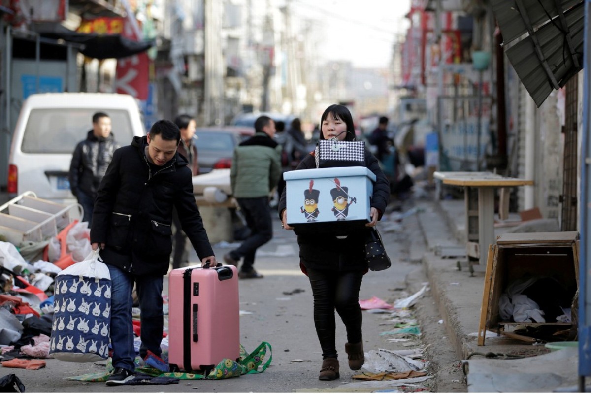 Beijing S Population Drops For First Time Since 2000 As Migrants Are - a couple leave their home in novembe!   r after they were required to move out in a