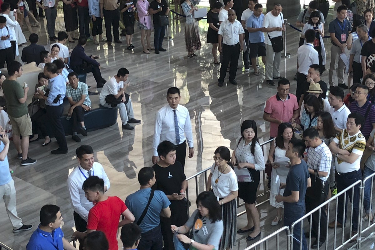 Prayers, lucky charms help Shenzhen home lottery entrants win a chance