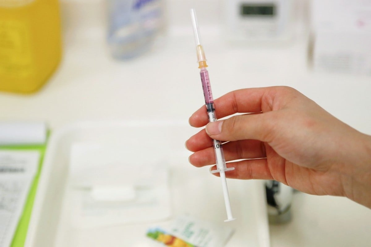 A nurse prepares a vaccine for a child at a hospital in Beijing. Photo: Reuters