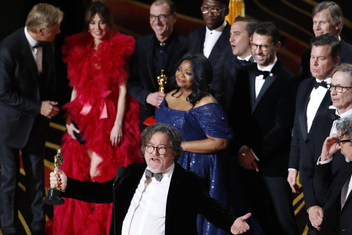 Producer Charles B. Wessler speaks onstage alongside cast and crew of Green Book after the film won the Best Picture award. Photo: Reuters