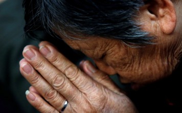 An underground Catholic churchgoer prays during a weekend mass in Tianjin. Photo: Reuters