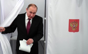 Russian President and Presidential candidate Vladimir Putin at a polling station during the presidential election in Moscow. Photo: Reuters