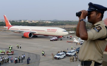 File photo of an Indian policeman watching over Begumpet Airport. Photo: AFP