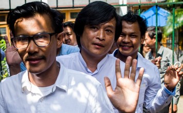 Journalists Kyaw Zaw Lin, left, followed by Nayi Min, centre, and Phyo Wai Win leave the court compound after the court hearing. Photo: AFP
