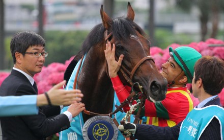 Joao Moreira gives Maurice a hug as trainer Noriyuki Hori looks on after the team combined to win the Champions Mile. Photo: Kenneth Chan