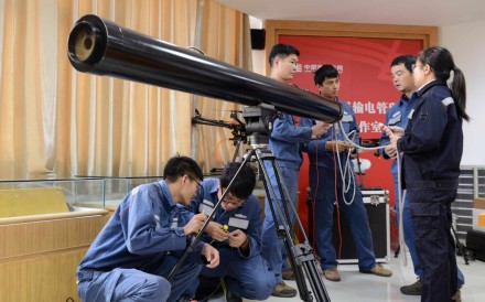 Power grid staff with the laser cannon. Photo: Handout