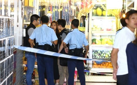 Police officers at the Alhambra Building in Yau Ma Tei, where the man was subdued. Photo: Handout
