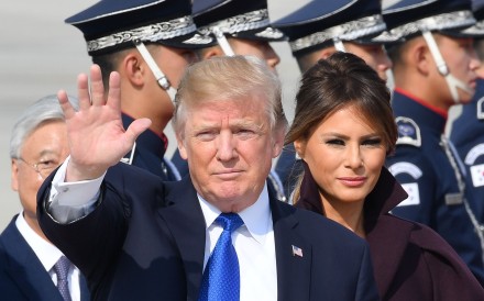 US President Donald Trump waves as he arrives at an air base in South Korea on Tuesday. He is expected to arrive in China on Wednesday before holding talks with President Xi Jinping the following day. Photo: AFP