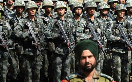 An Indian soldier stands in front of a group of Chinese troops after taking part in a joint anti-terror drill last year. Chinese diplomats are hoping to build bridges with India after tensions between the two Asian giants hit rock bottom earlier this year. Photo: AFP