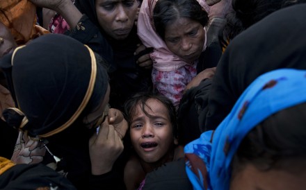 A Rohingya Muslim child cries as she stands amid a crowd receiving food rations near a refugee camp in Cox's Bazar, Bangladesh in September. Photo: AP