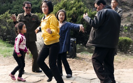 A family dances to music in Moranbong park, a popular spot in central Pyongyang. Locals gather here for barbecues and picnics and it is a favoured backdrop for wedding photos. Locals are thrilled when foreign visitors join in with the dancing.