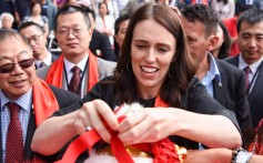 New Zealand Prime Minister Jacinda Ardern hangs auspicious red flags on a lion dancing costume during the 2019 Lunar New Year festival in Auckland. Photo: Xinhua
