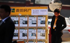 A real property agent checks a property advertising board in Beijing. According to a report by the Chinese government, property brokerages are among the country’s least scrupulous group of firms. Photo: Agence France-Presse