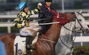 Neil Callan returns to the winner's circle on Rewarding Hero, two races after an improper riding incident with Eddy Lai Wai-ming - perhaps giving a demonstration. Photo: Kenneth Chan