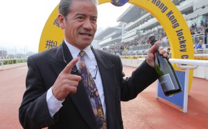 Tony Cruz shows off his bottle of champagne as he celebrates his 1,000th win as a trainer. Photos: Kenneth Chan