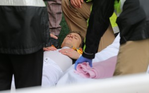 Zac Purton is attended to by medical staff after collapsing at Sha Tin on Sunday. Photo: Kenneth Chan 