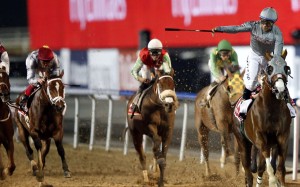 Jockey Victor Espinoza (right), on California Chrome, celebrates after winning the US$10 million Dubai World Cup at the Meydan track last night. Photo: EPA