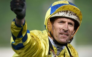 Hugh Bowman is covered in mud after winning the QE II Cup on a rare yielding surface. Photo: AFP