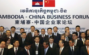 Cambodian Prime Minister Hun Sen (centre, first row), poses for a group photo at the China-Cambodia Business and Financial Development Forum on December 1. The forum, jointly organised by CMIG and Cambodiaís Ly Yong Phat Group, was held to promote Chinese investment in Cambodia. Photo: EPA