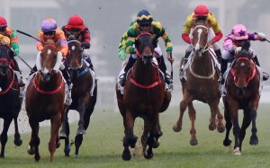 Hugh Bowman (blue, green and yellow silks) wins the Classic mile with Furore. Photos: Kenneth Chan