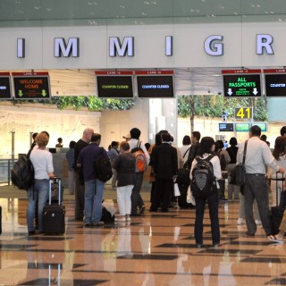 File photo of visitors queuing up at the immigration counter at Changi International Airport in Singapore. Photo: AFP