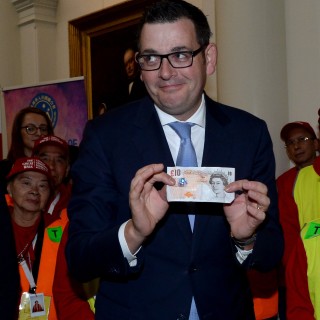 Victorian Premier Daniel Andrews holds a British ten pound note at a function to formally apologise to descendants of Chinese migrants who were targeted by a racist ten pound tax some 160 years ago. Photo: EPA
