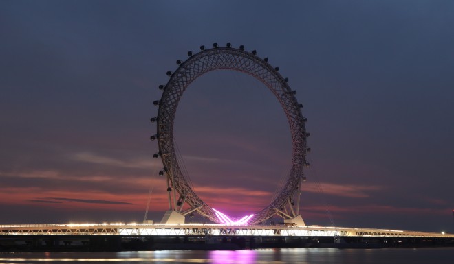 The wheel is lit up at night.