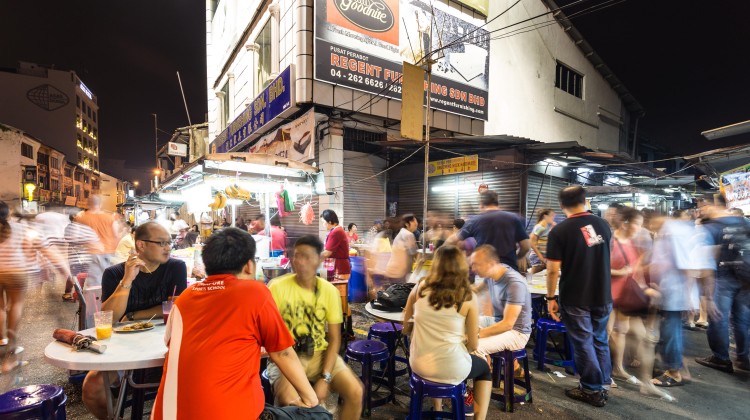 People enjoying street food at a night market in George Town in Penang. Photo: Alamy