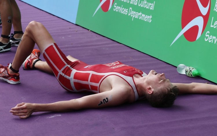Denmark's Henrik Klemmesen lies flat out after learning he had been disqualified in Sunday's Hong Kong ASTC Sprint Triathlon Asian Cup at Sunny Bay, Lantau. Photo: Jonathan Wong