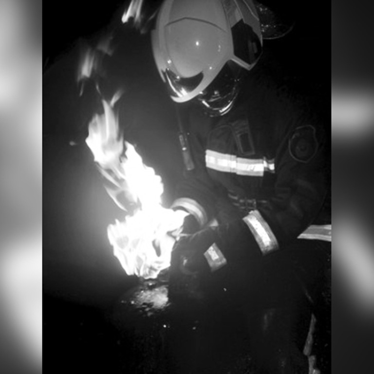 Beijing firemen pull burning gas cylinders from building to prevent